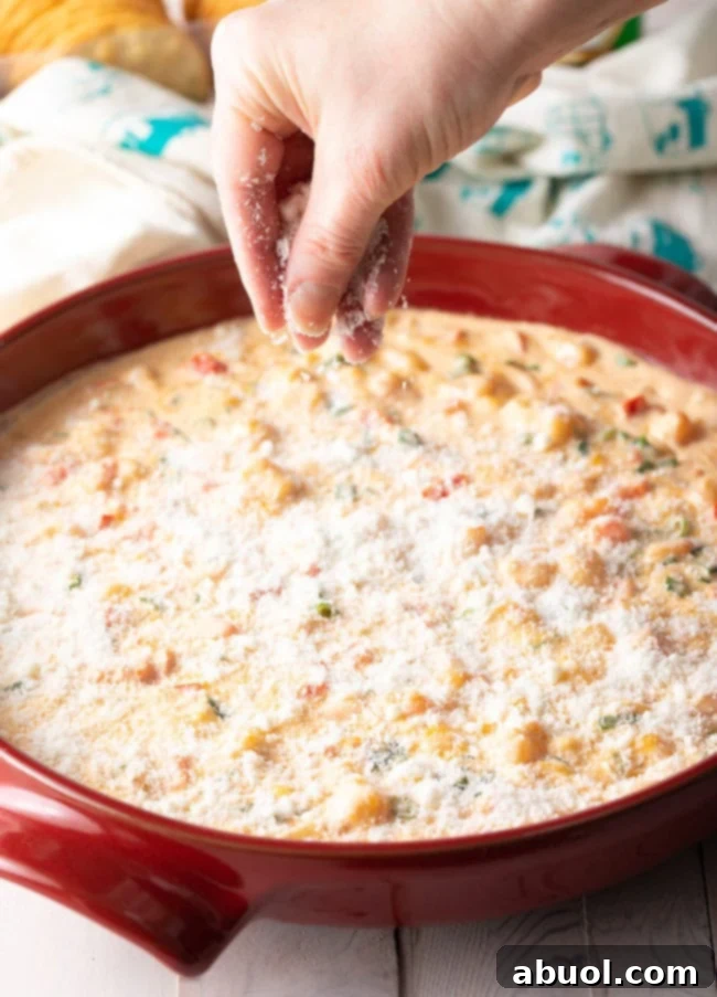 A vibrant, close-up shot of the freshly baked Cheesy Shrimp Dip, bubbling and golden-brown at the edges, ready to be served.