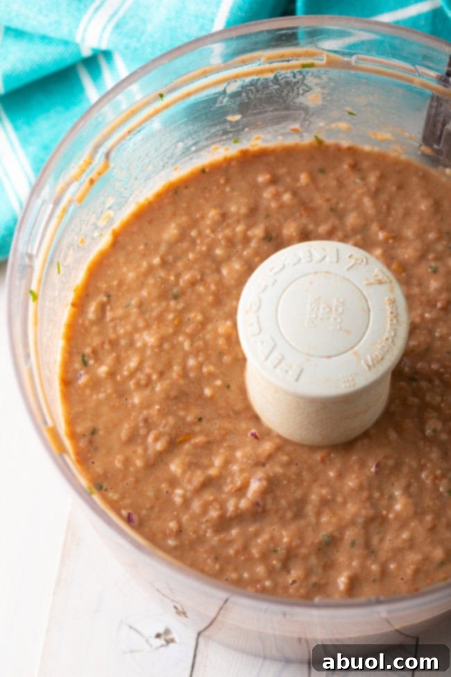 Blending bean dip in a food processor.