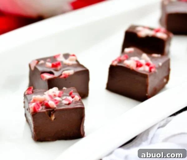 Peppermint Fudge cut into pieces on a platter, ready to be served or gifted for the holidays.