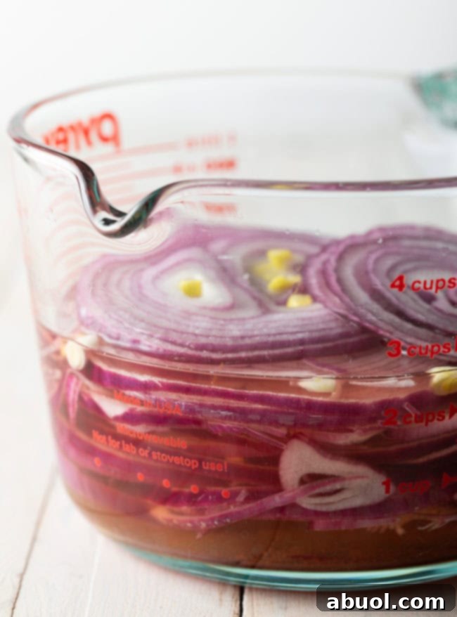 A jar of freshly made quick pickled red onions, ready to be enjoyed as a vibrant and tangy topping