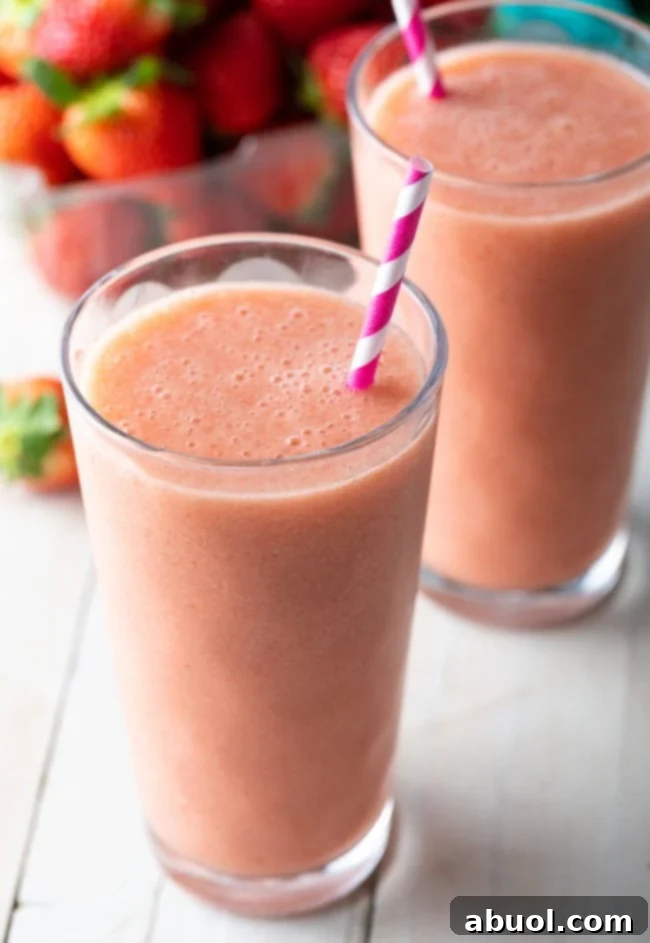 A vibrant Smoothie King Caribbean Way smoothie in a tall glass, ready to be enjoyed.