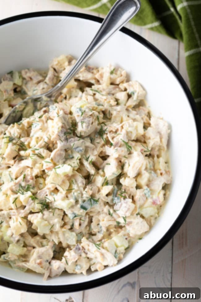 Top down view of southern chicken salad in a white and black bowl.