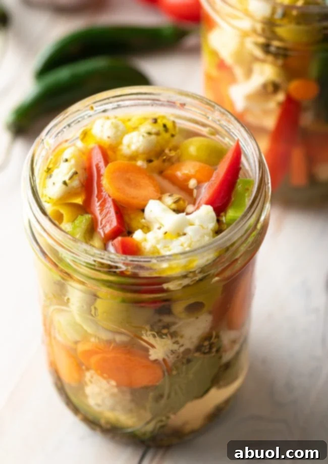 Zesty Italian Giardiniera 2 Homemade giardiniera pickled vegetables in a jar, showcasing a colorful mix of veggies.