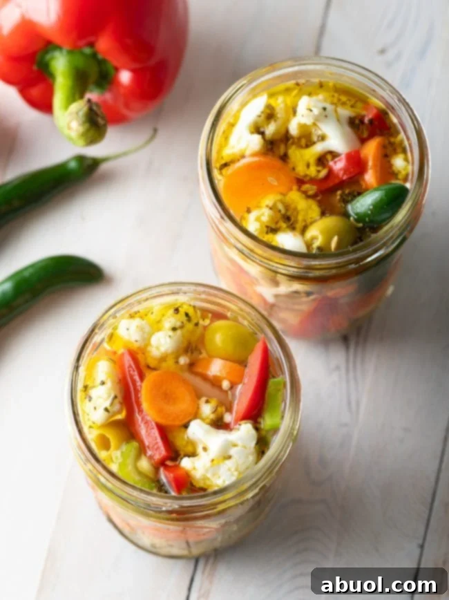Zesty Italian Giardiniera 11 Overhead shot of Giardiniera Pickled Vegetables in jars, showcasing multiple batches.