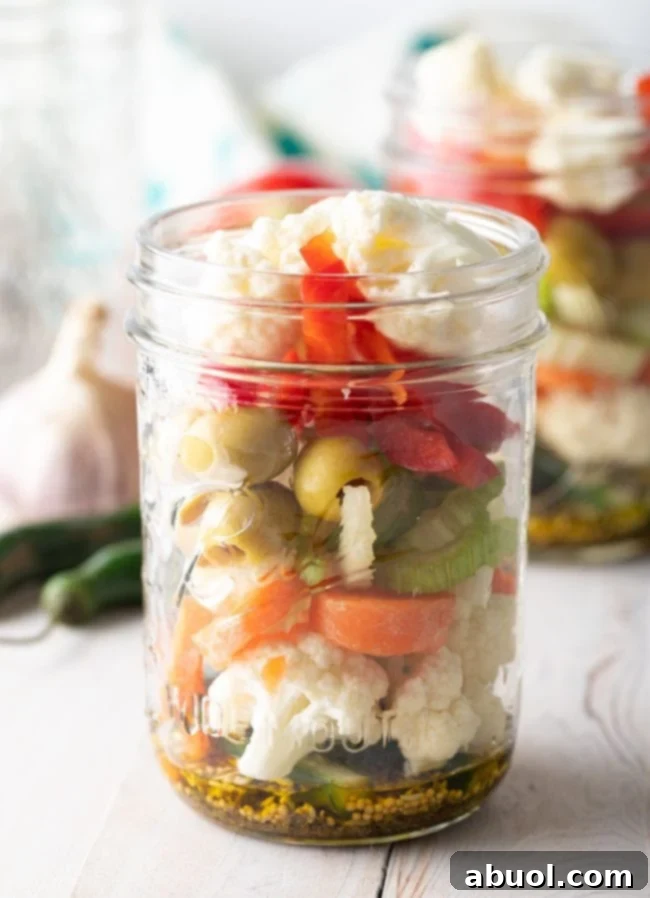 Zesty Italian Giardiniera 8 Jars being filled with chopped vegetables and spices.