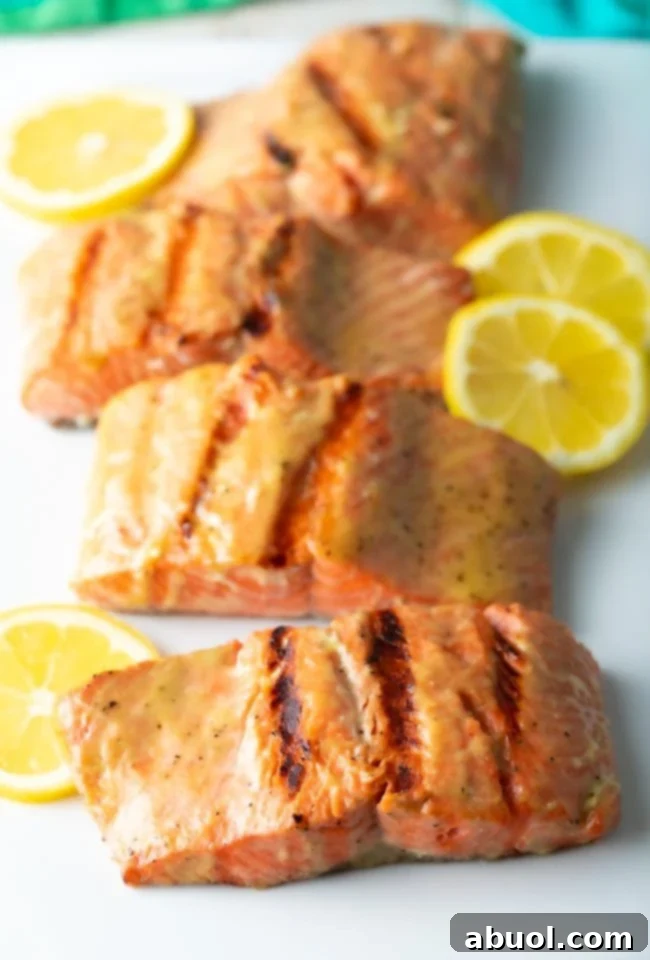 Grilled salmon filets on white platter.