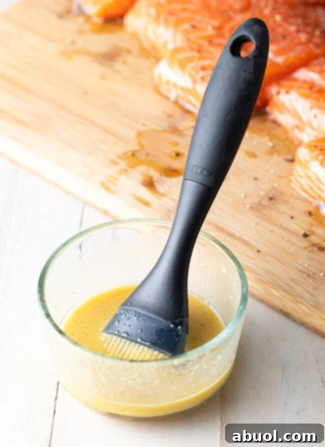 Prepped marinade in a glass bowl with a brush. 