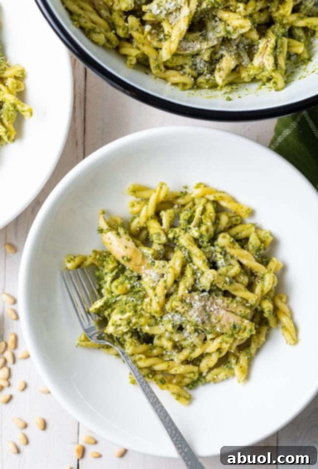 basil pesto pasta recipe in serving bowl and small white bowls