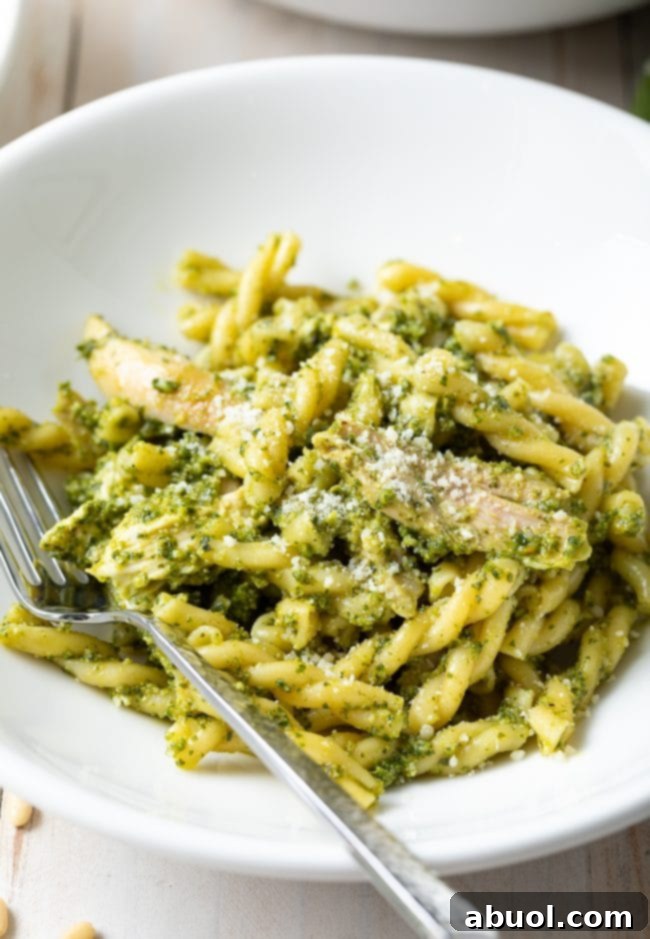 chicken pasta with homemade pesto - close up shot with fork