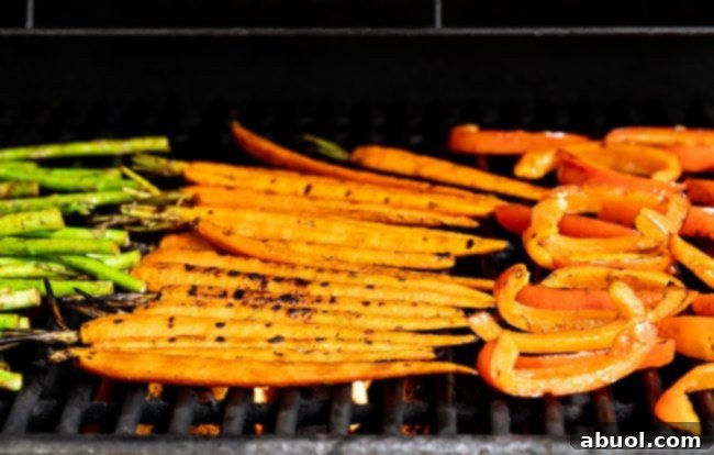 Master Marinade for Grilled Vegetables 9 A close-up of a hand using tongs to expertly flip partially grilled carrots on a hot grill, revealing their caramelized surfaces.