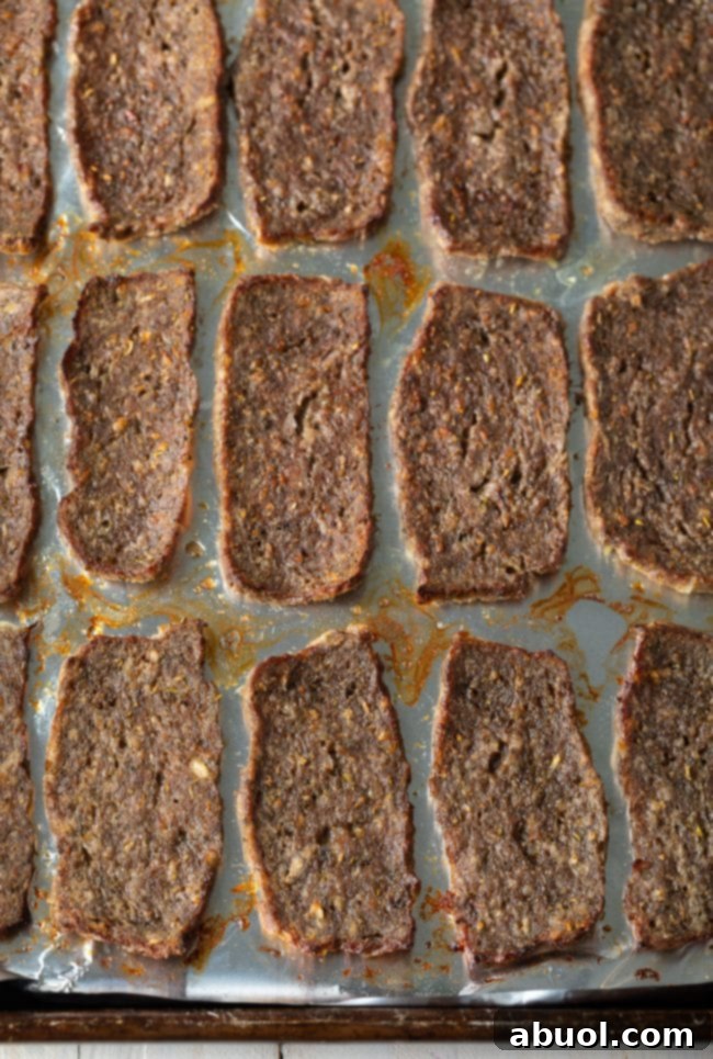 Pieces of lamb on a sheet pan after getting crispy in the oven.