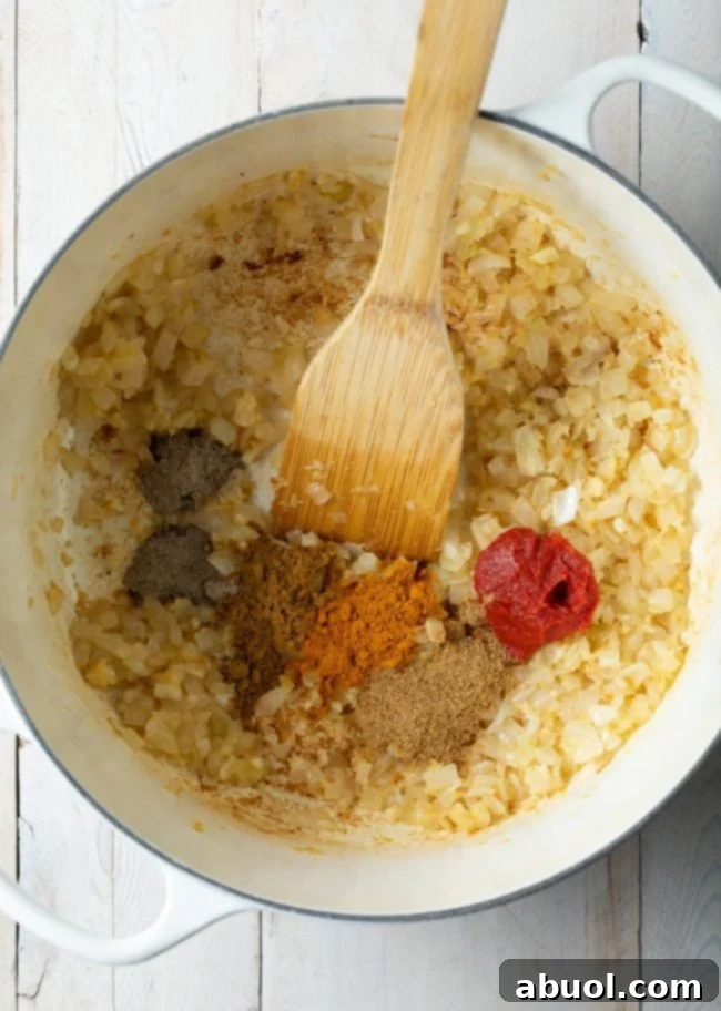 Perfect Mung Dal Recipe 5 Close-up of various Indian spices in a pot, including turmeric, cumin, and cardamom
