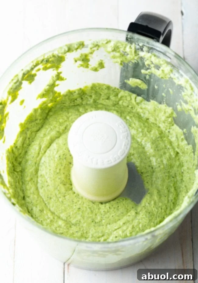 Creamy pesto in a food processor after being mixed. 