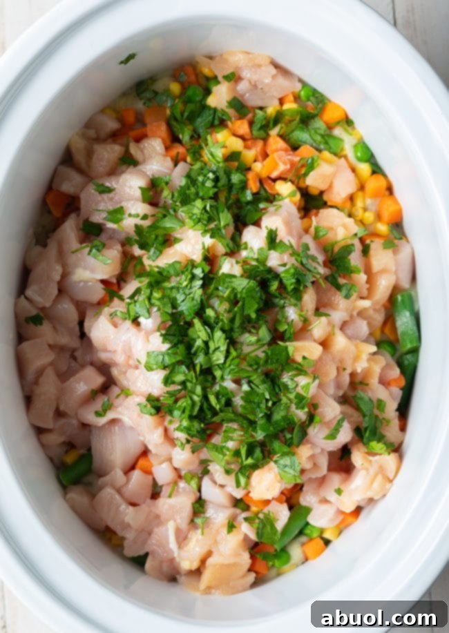All the chicken pot pie ingredients mixed together in the crockpot, ready for slow cooking.