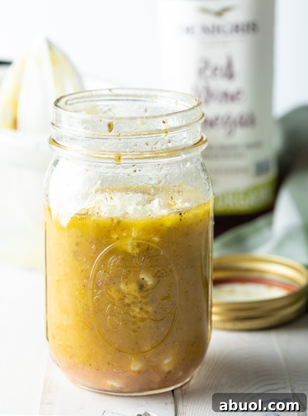 Zesty Homemade Greek Dressing 4 A glass jar filled with vibrant Mediterranean Salad Dressing, ready to be served or stored.