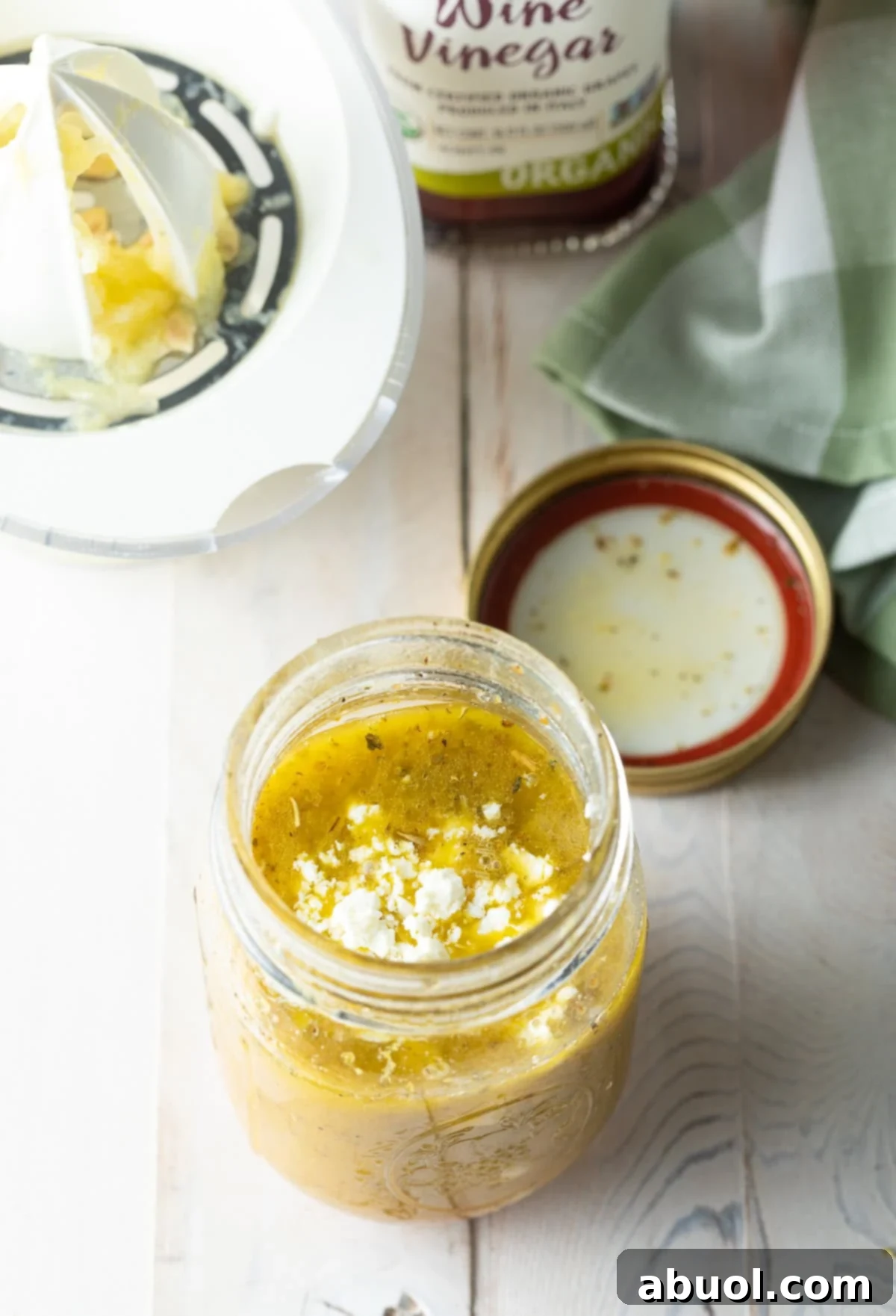 Zesty Homemade Greek Dressing 7 A small bowl of fresh, crumbled feta cheese, an optional but delicious addition to Greek salad dressing.