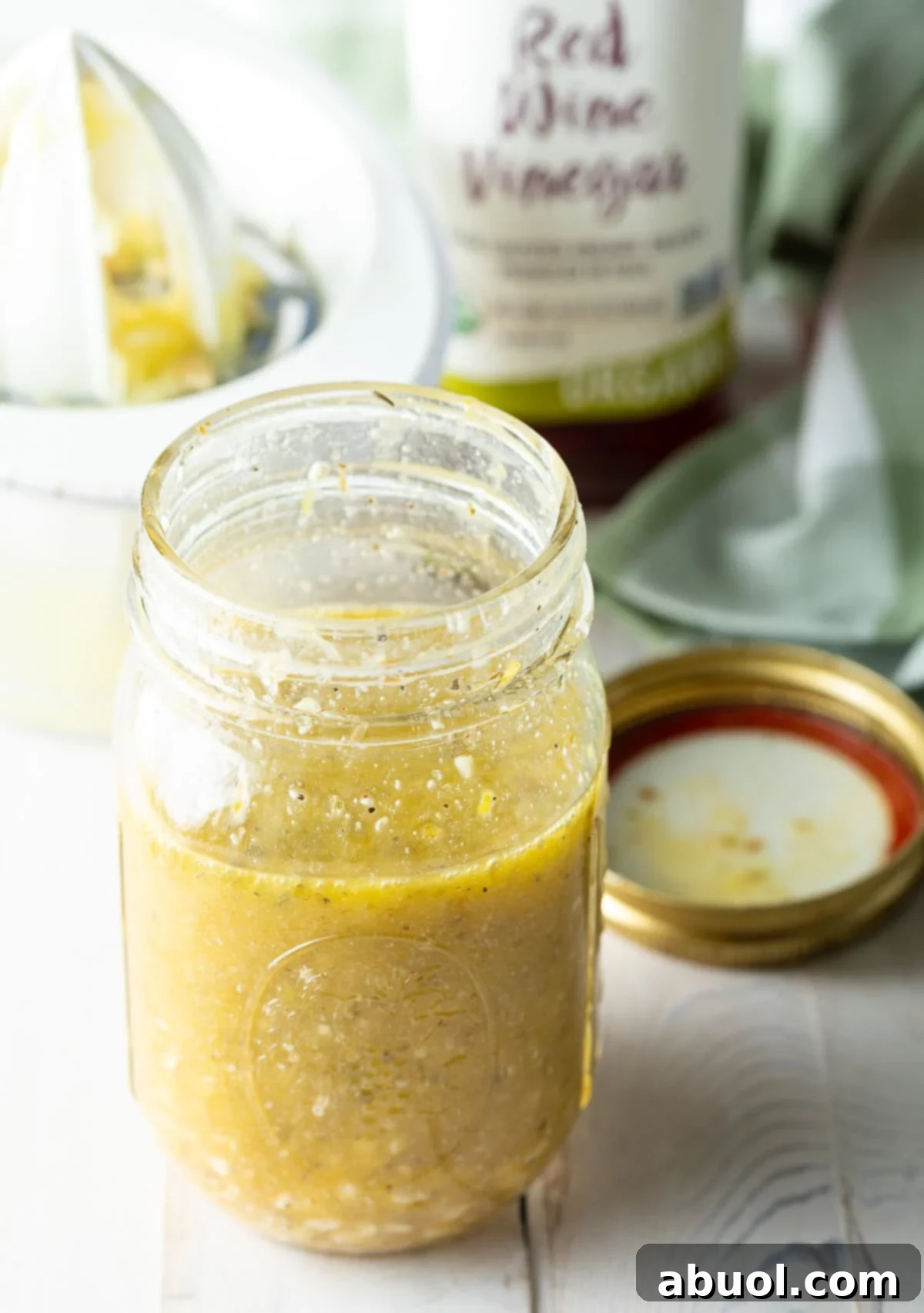 Zesty Homemade Greek Dressing 8 Red wine vinegar, a crucial acidic component, alongside other ingredients for making a Greek vinaigrette.