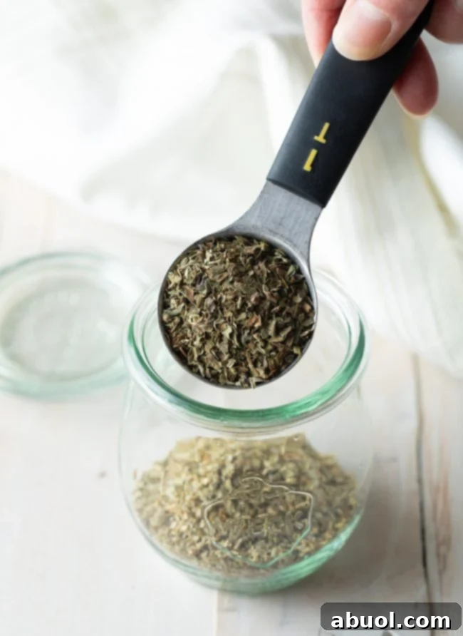 Variety of Italian herbs displayed on a wooden board