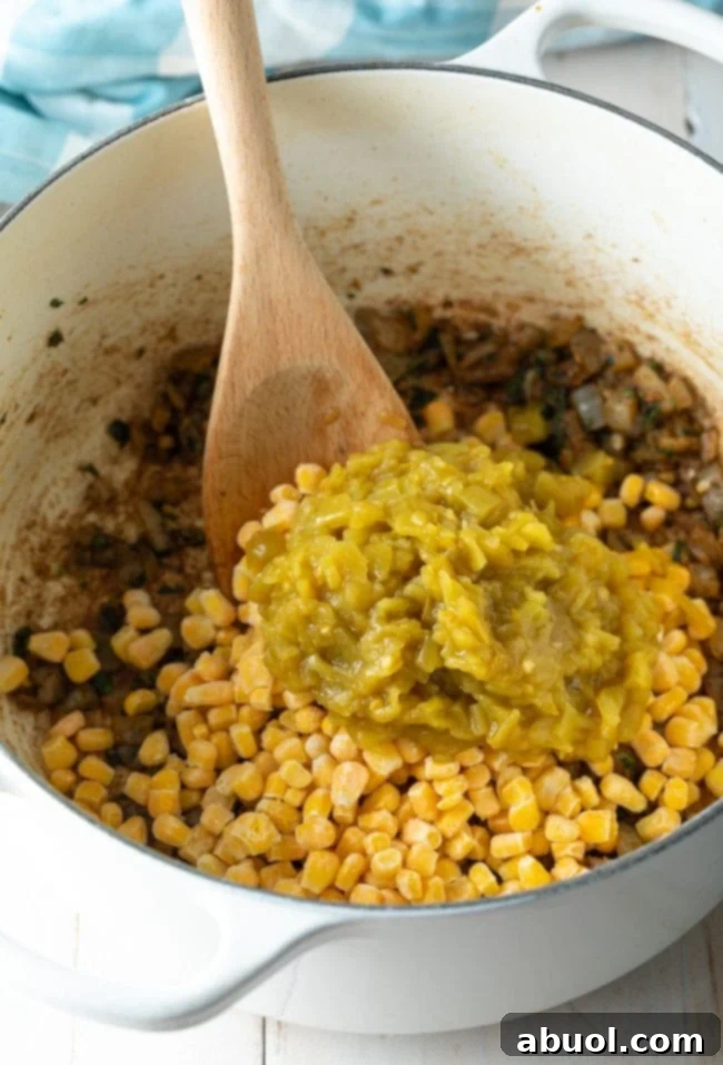 corn and green chiles added to pot