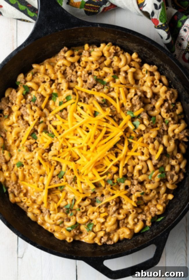Overhead view of homemade hamburger helper in a large skillet, ready to be served.
