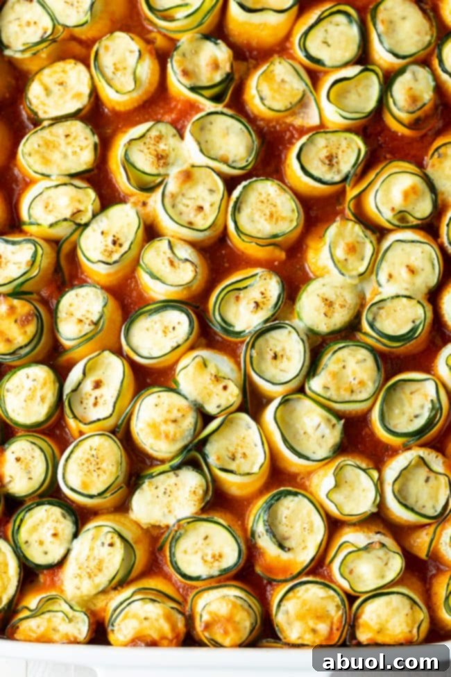 Overhead shot of keto lasagna roll ups in a marinara sauce. 
