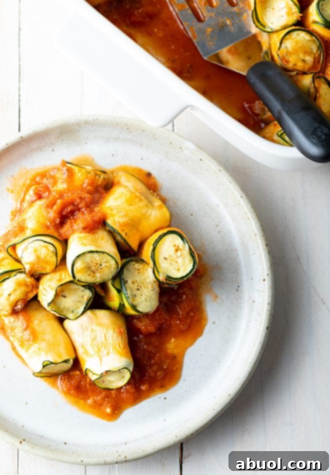 plate of low carb lasagna roll ups next to the baking dish full of them. 