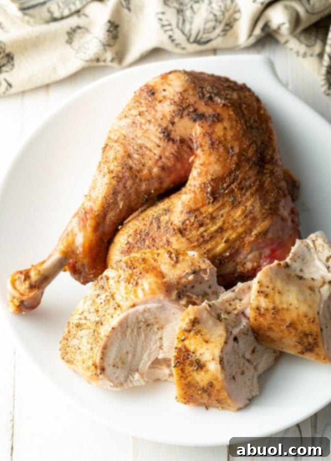 A succulent spatchcocked turkey, expertly carved into various pieces of breast, thigh, and drumstick, arranged on a cutting board.