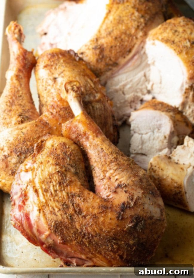 A close-up shot of a perfectly cooked, juicy spatchcock turkey leg, ready to be carved.