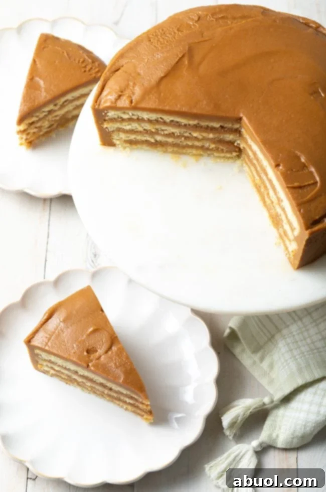 top view of this caramel cake recipe on a stand with a few pieces on scalloped dishes