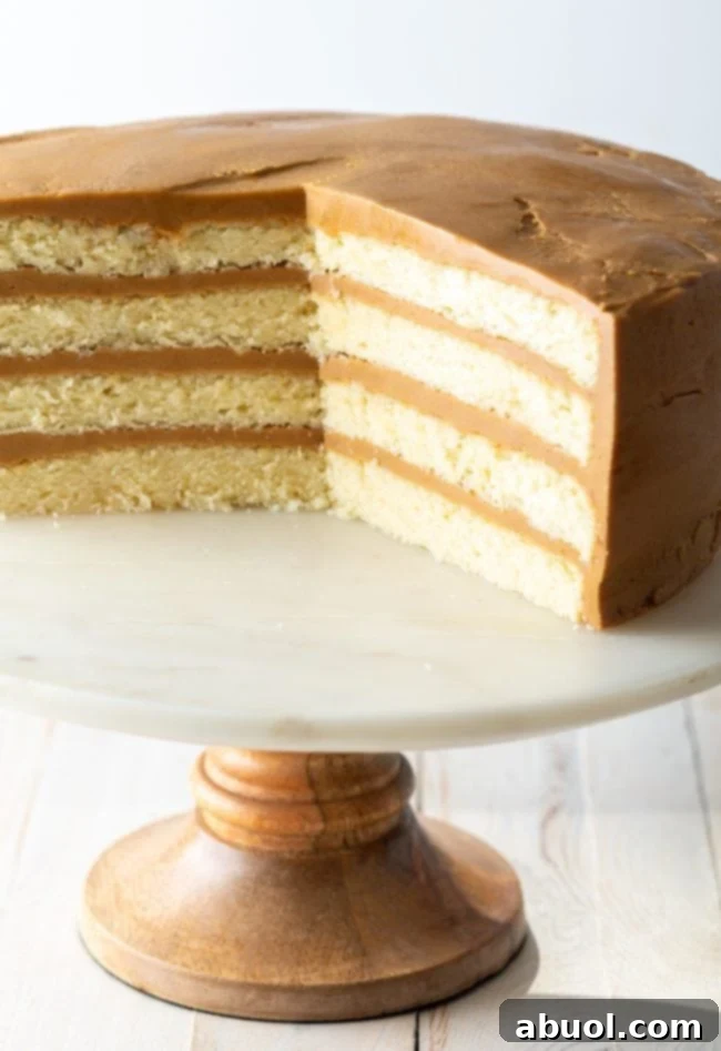 southern caramel cake layers of cut cake shown clearly on this marble and wood stand