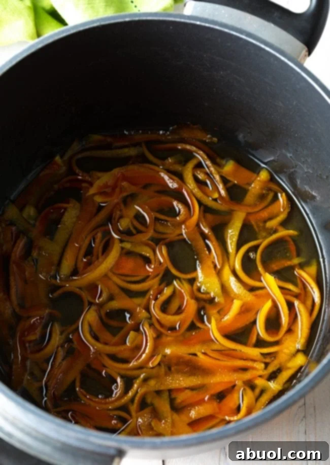 How to Candy Orange Peel - orange peels simmering in water