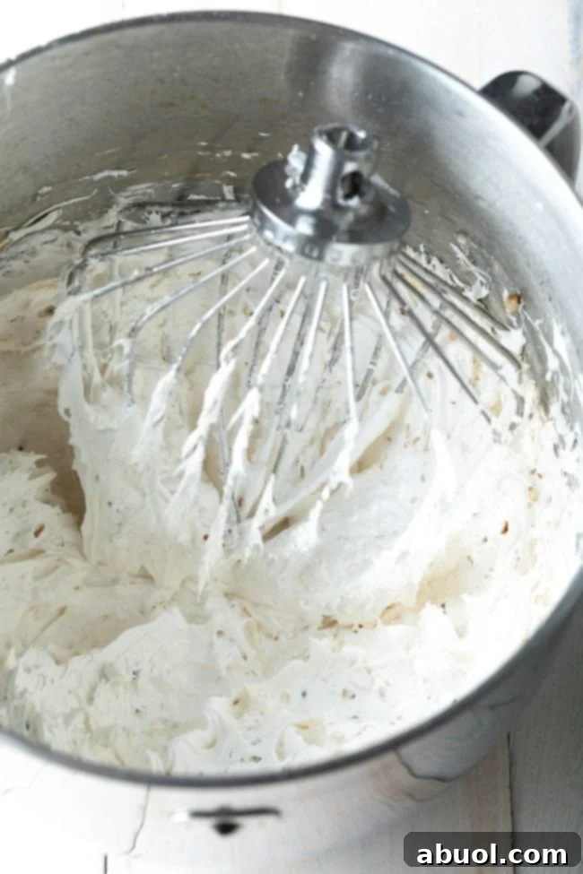 Whipped meringue for the divinity recipe in a stand mixer with the whip attachment. 