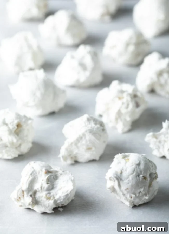 Divinity candy scooped onto a baking sheet lined with parchment paper. 