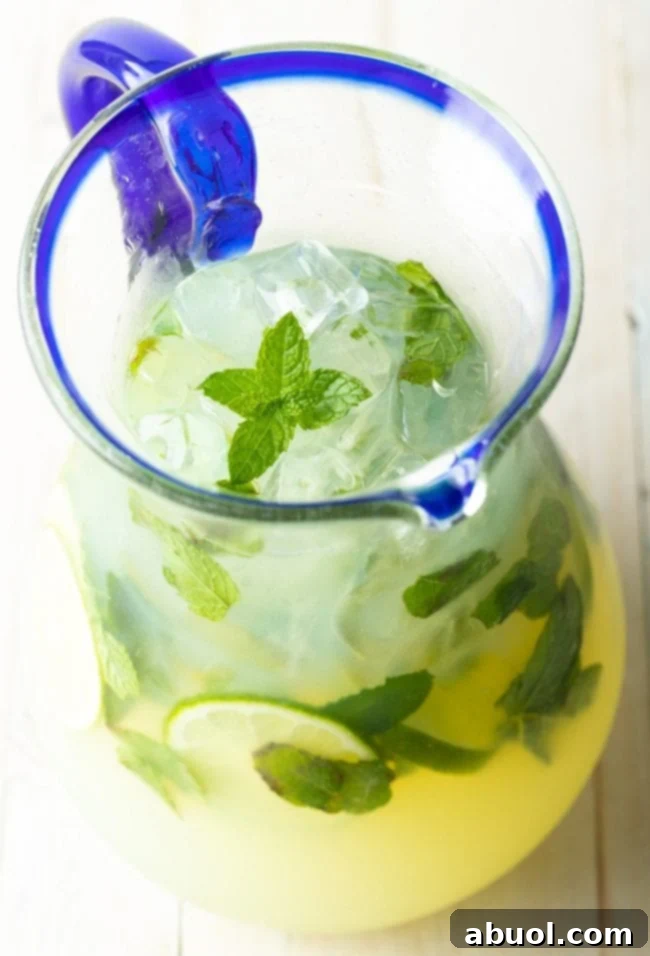 A beautifully set table with a pitcher of mojitos, suitable for a party, offering virgin or alcoholic options.