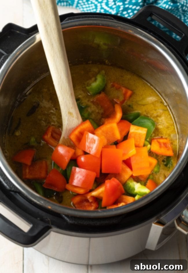 Vibrant Instant Pot Green Curry 8 Overhead of bell peppers being added into the Instant Pot.