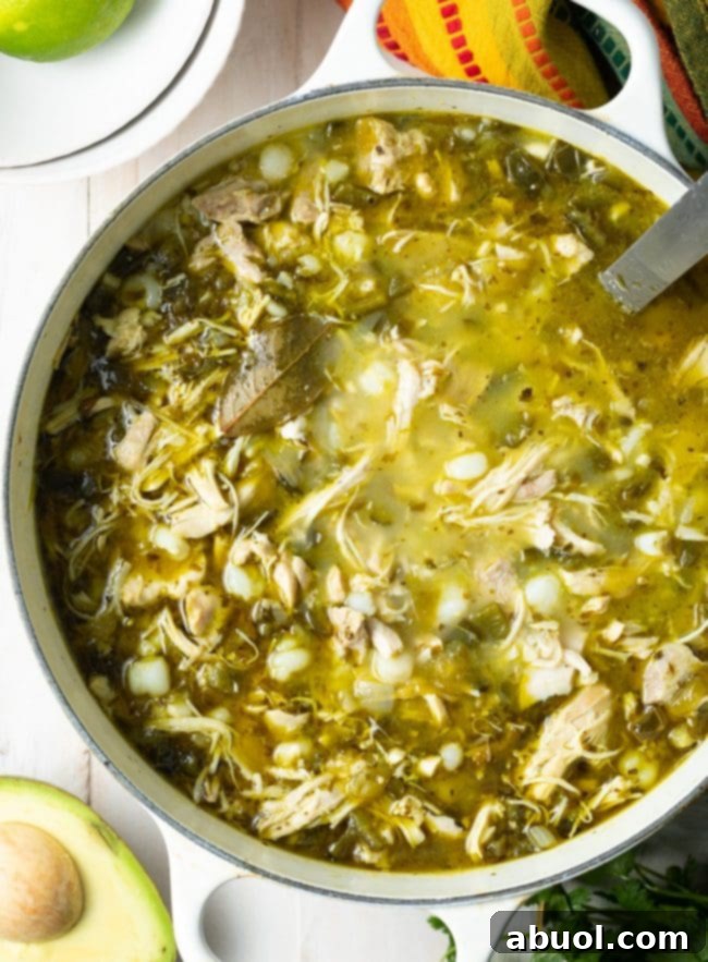 Overhead shot of green pozole in a pot. 