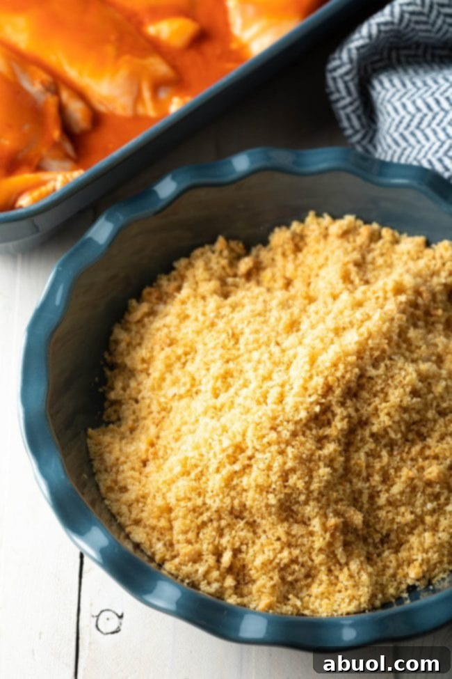 Panko breadcrumbs and ranch seasoning mixed in a pie pan, ready for breading the chicken.