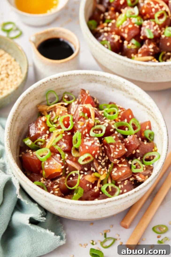 A vibrant bowl of Hawaiian Ahi Poke, garnished with fresh ingredients and ready to be served, emphasizing its appealing presentation.