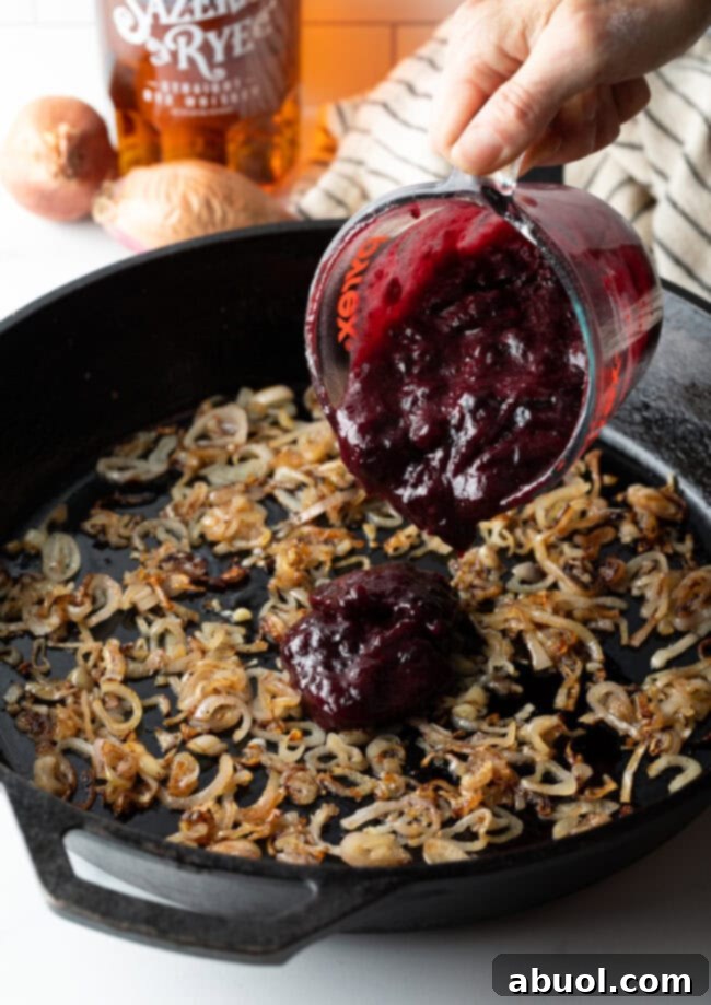 Preparing homemade blackberry sauce for duck breast