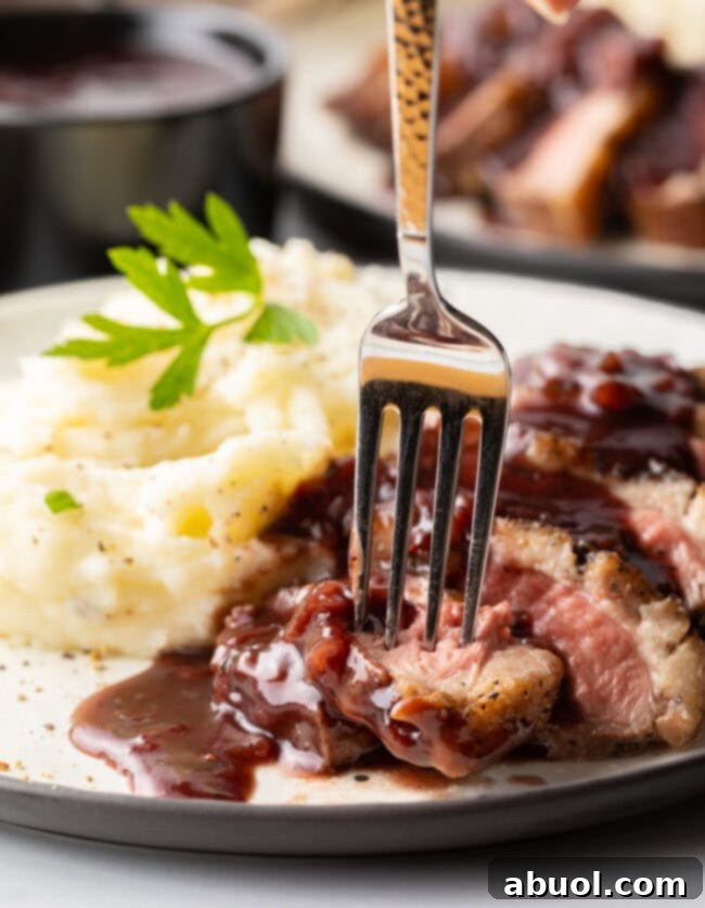 Best duck recipe - fork picking up slice of duck breast from plate