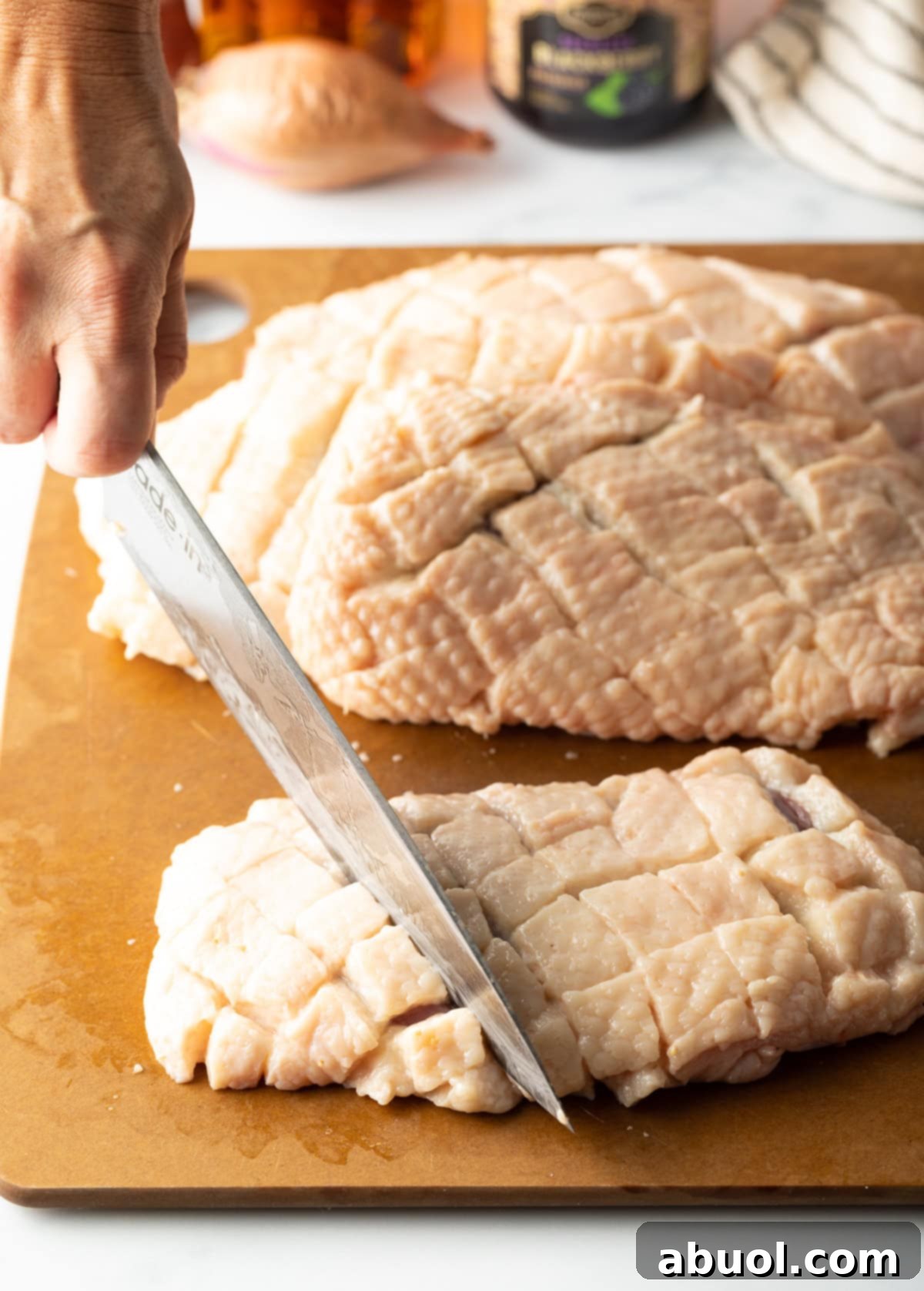 Step 3: Scoring duck fat in a criss-cross pattern for optimal rendering