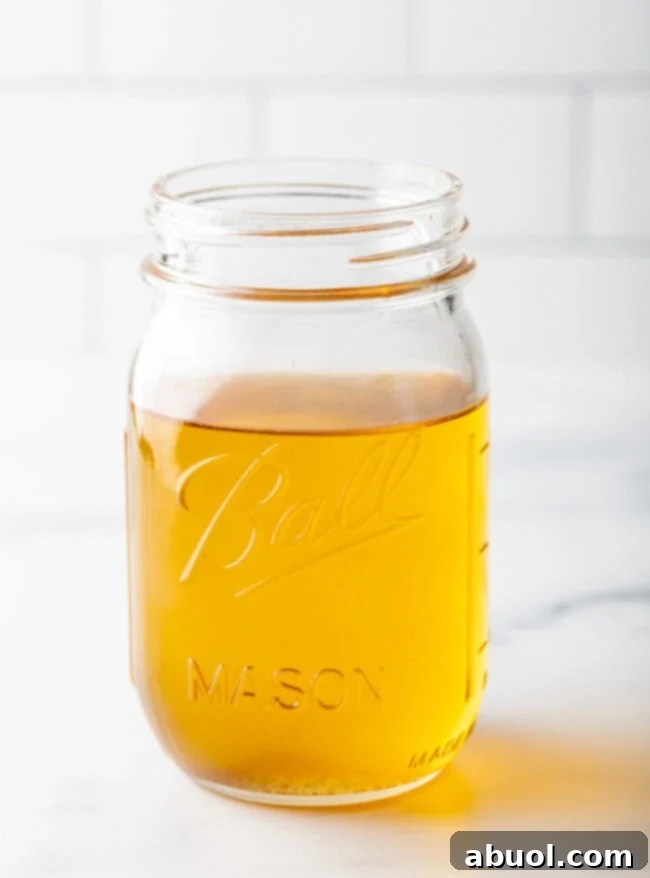 Reserved rendered duck fat stored in a glass jar