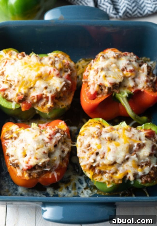 Hearty Keto Stuffed Peppers 8 Baked keto stuffed peppers, fresh out of the oven, with perfectly melted, golden-brown cheese on top.