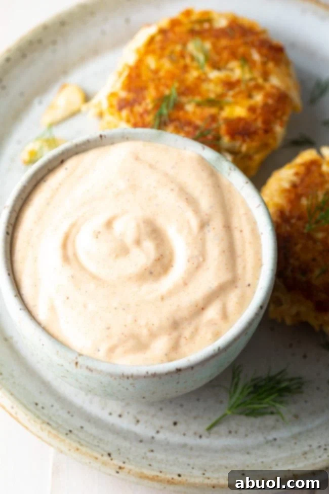 Remoulade sauce served with crab cakes on a plate. 