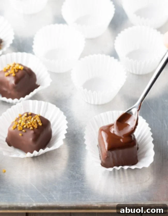 Decadent Chocolate Petit Fours 9 coating the mini cake with chocolate