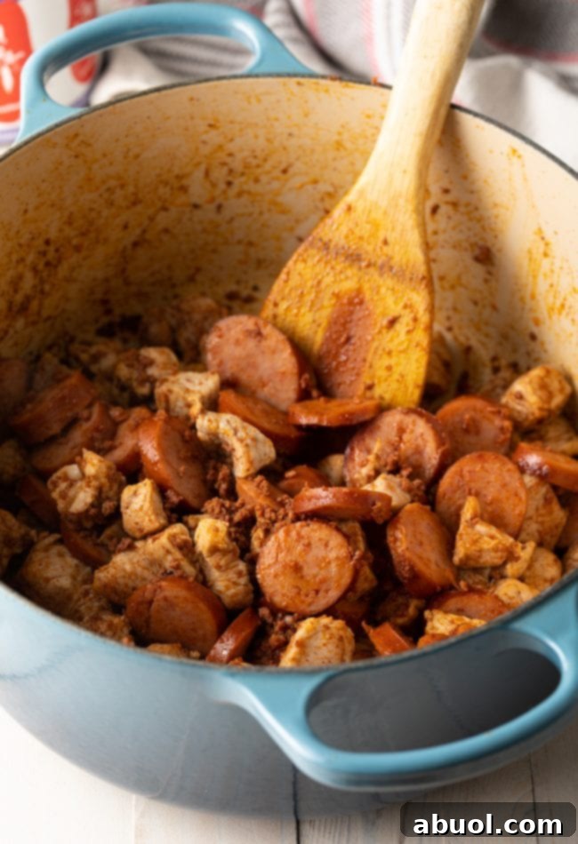 A wooden spoon gently stirs the rich, dark Brazilian Feijoada stew within a large, steaming pot, showcasing the various cuts of pork and black beans melding together.