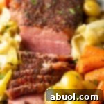 A beautifully cooked oven-baked corned beef and cabbage dish, showcasing the tender meat and vibrant vegetables.