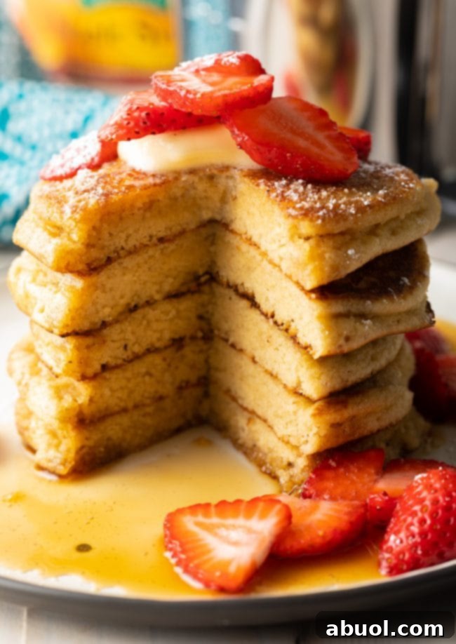A delectable stack of perfectly cooked almond flour pancakes, showcasing their golden-brown edges and soft interior, ready to be enjoyed