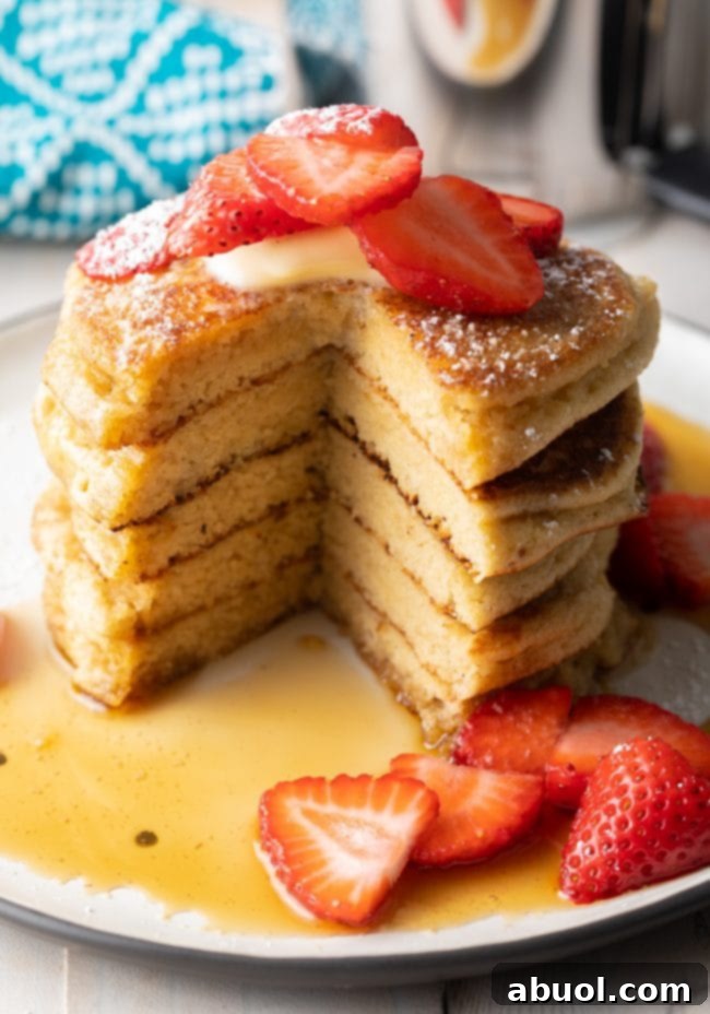 A close-up shot of freshly made, scratch-made fluffy almond flour pancakes, showcasing their appealing texture and golden hue, perfect for any breakfast or brunch table