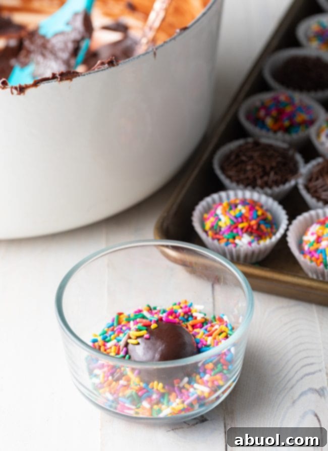 Shot of Brazilian truffle fudge balls being coated in sprinkles. 